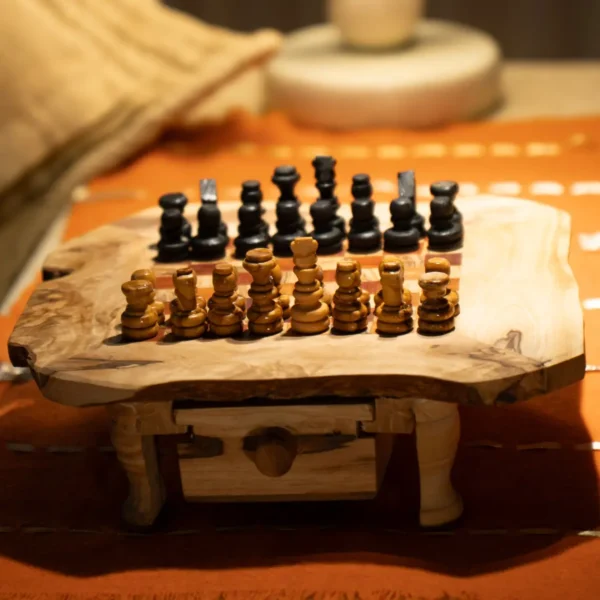Olive wood chess pieces on irregular rustic board, close-up view