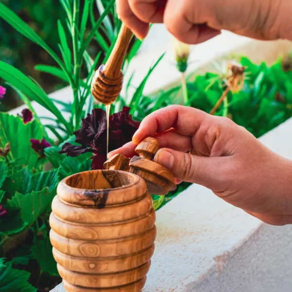 Olive wood honey dipper, close-up of grooved head