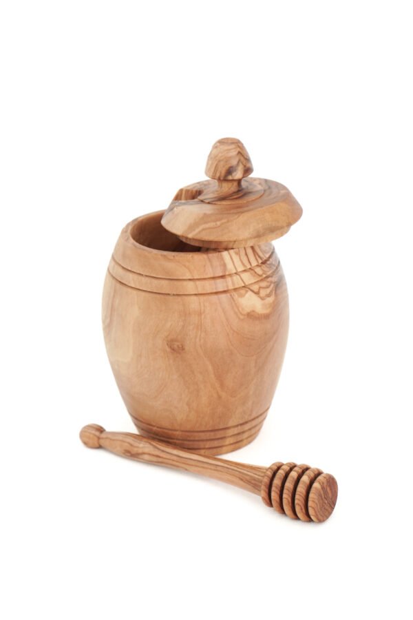 Olive wood honey pot with lid and wooden dipper, close-up