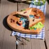 Olive wood heart-shaped board styled with cheese
