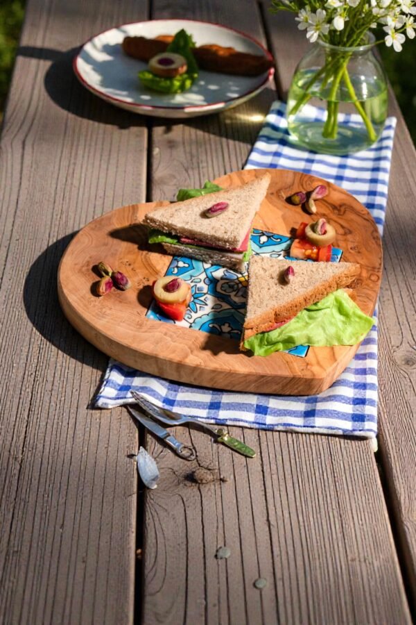 Olive wood heart-shaped board styled with cheese