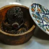 Olive wood storage bowl, close-up of ceramic lid